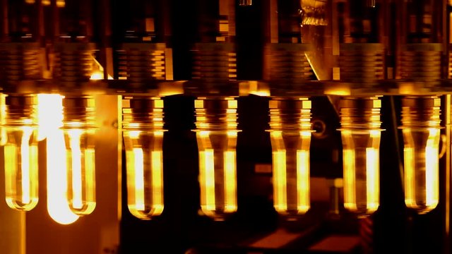 PET bottle preforms. The operation of PET bottle or plastic bottle blowing machine with lighting effect.