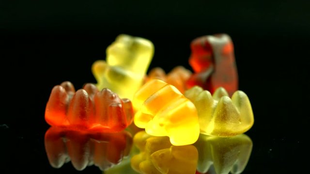 Gummy bears closeup. Colorful jelly sweets. Rotation 360 degrees. 4K UHD video 3840x2160