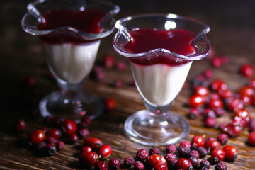 fruit jelly with berries in glasses on wooden table
