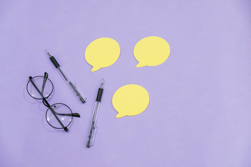 work Desk glasses kicking notepad pencils Top View. yellow and purple color. the concept of creating ideas