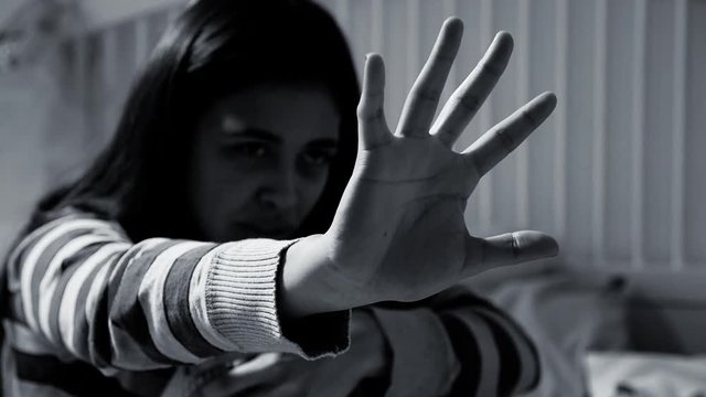 Stop the violence woman holding hand against violence and harassment black and white