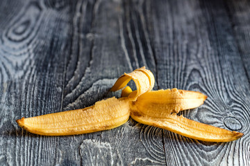 Banana skin lying on a wooden surface