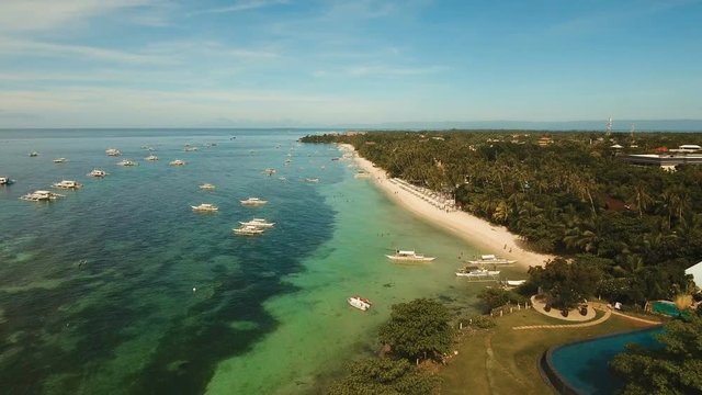Aerial view of tropica Alona beach on the island Bohol, resort, hotels, Philippines. Beautiful tropical island with sand beach, palm trees. Tropical landscape. Seascape: Ocean, sky, sea. 4K video