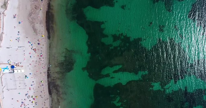 ALGHERO, SARDINIA, ITALY  &ndash; JULY 2016 : Aerial shot over Alghero beach on a beautiful day with people and waves in view