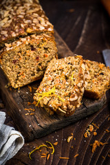 Carrot cake sliced on wooden rustic board.