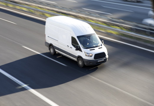 White delivery van blurred motion