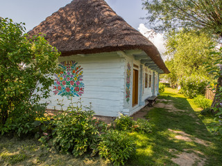Fototapeta na wymiar Colourful log house in the yard of Felicia Curylowa