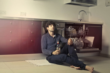 Man drinking in the kitchen