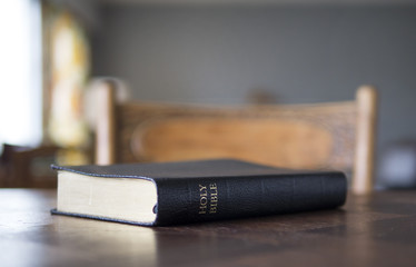 Closed Bible on table.