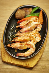 Japanese seafood. Fried spicy shrimps with herbs