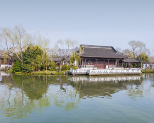 Fototapeta na wymiar Ancient pavilion at dusk in early spring, located at Slender West Lake. The lake is a well-known scenic spot in the city of Yangzhou in Jiangsu province, China.