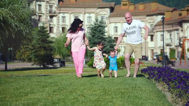 Happy family having fun outdoors in summer park. 4K