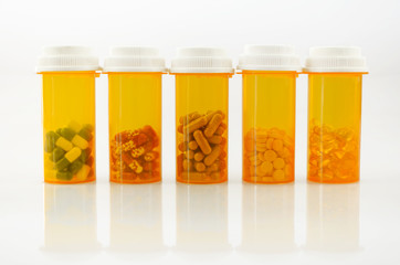 Medicine in light protected bottle. Capsules in orange bottle. Refill prescription concept.
