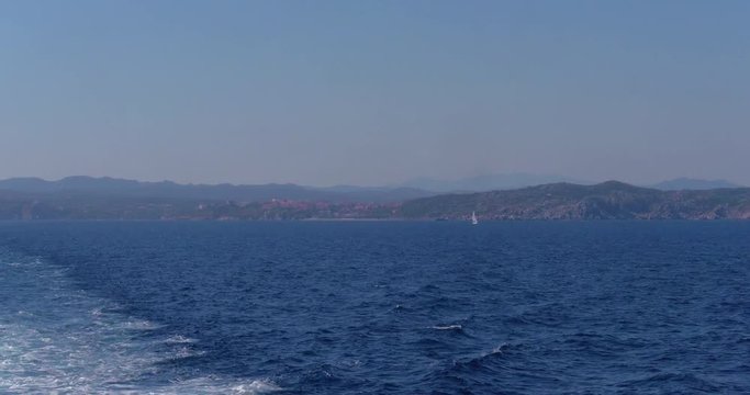 Video shot from a ship moving on sea on a sunny day with Paula cityscape in view