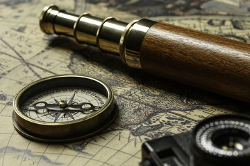 Retro compass with old map and spyglass