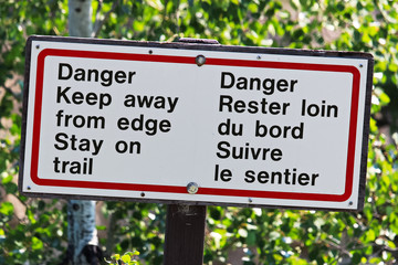 Danger keep away from edge stay on trail sign