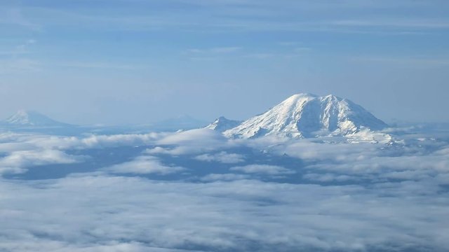 the aerial view of mount rainier, mount adams and mt st helens near seattle washington