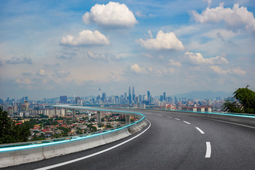 Highway overpass with modern city background . Noon scene .