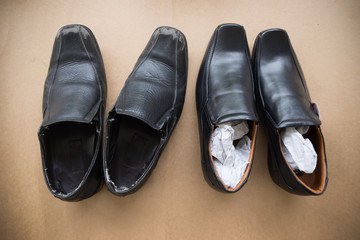 Old shabby shoes in comparison with new and expensive ones.