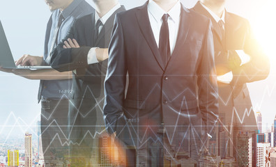 Business partner team standing together , double exposure effect with cityscape and stock statistics graph .