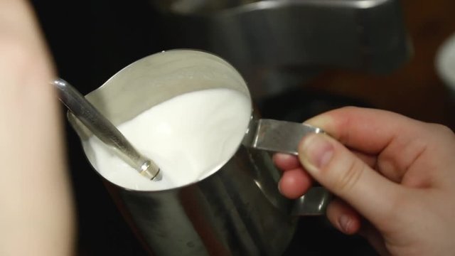 pour the milk from the coffee machine