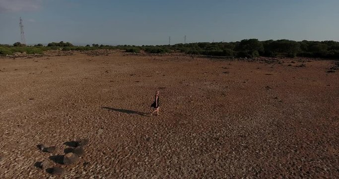 SARDINIA, ITALY  &ndash; JULY 2016 : Aerial shot over Giara di Gesturi landscape on a beautiful day with girl waking in view