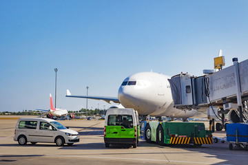 Preparation of aircraft for departure from airport terminal. Service of the aircraft before the flight. Plane at airport on clear sunny day.