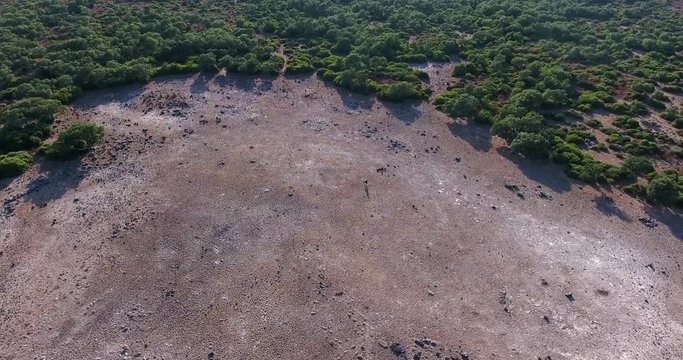Aerial shot over Giara di Gesturi landscape on a beautiful day with girl waking in view