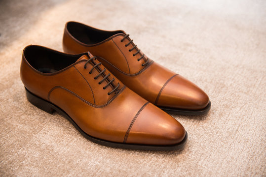 Brown leather classic male shoes on the floor