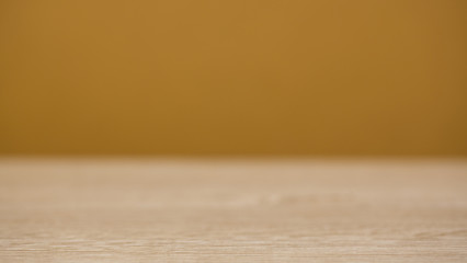 Wooden countertop on a blurry brown background