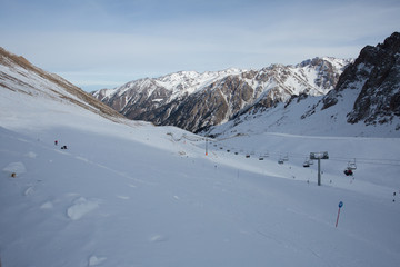Fototapeta na wymiar The cable car in the snowy mountains Chimbulak
