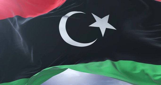 Libya flag waving at wind with blue sky in slow, loop