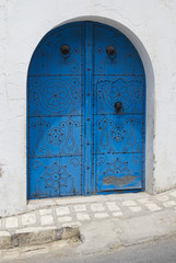 Blue wooden door with arch from Sidi Bou Said in Tunisia