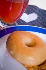 donut for breakfast or snack with glass of orange juice
