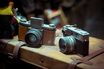 Old retro cameras on vintage suitcase