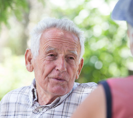 Two senior men talking in park