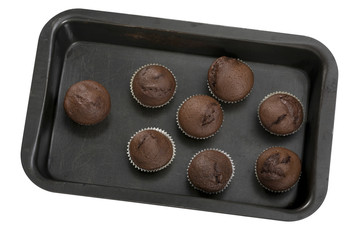 Dark chocolate muffins in baking tray isolated on the white background