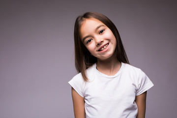 Fototapeta premium Portrait of Beauty happy little girl a on gray background