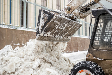 Machine remove snow from a city street