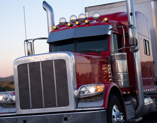 Red American long haul big rig semi truck with accessories