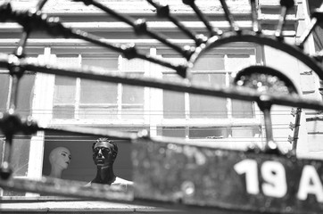 Couple relationships. A mannequin man leaning out of the window is indifferent to the woman.