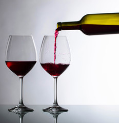 Bottle and glasses of red wine.
