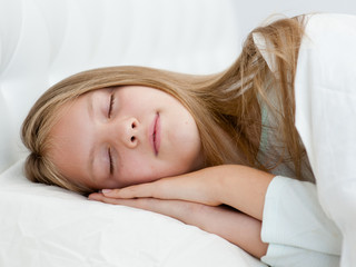Beautiful teen girl sleeping in bed