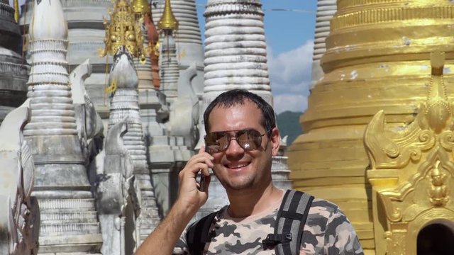 Male Tourist Visits Burmese Pagodas Talking on Mobile Phone