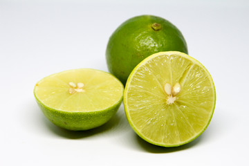 Half of lime citrus fruit isolated on white background. Sliced lemon half