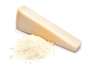 a piece of Parmesan and grated cheese on white background