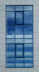 large opaque window with a reflection of a blue sky