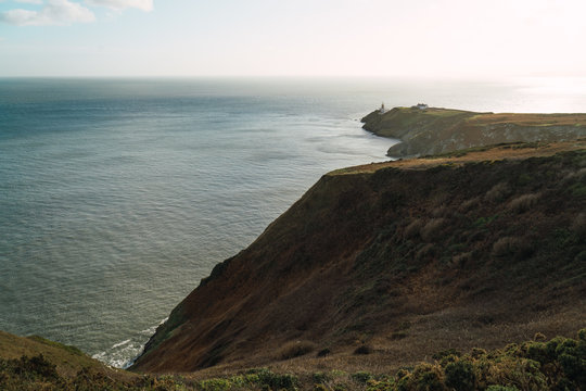 Big coastal rock and calm ocean