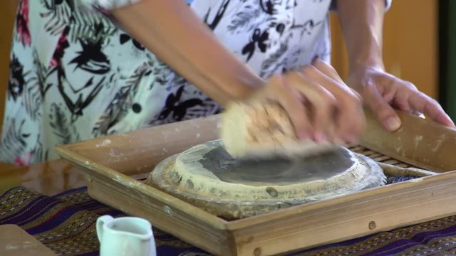 Rubbing Thanaka Bark on Grind Stone