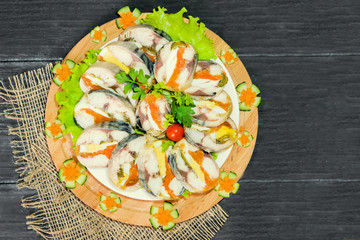 Roulade of sea fish mackerel with boiled vegetables and eggs, gala dinner, close-up